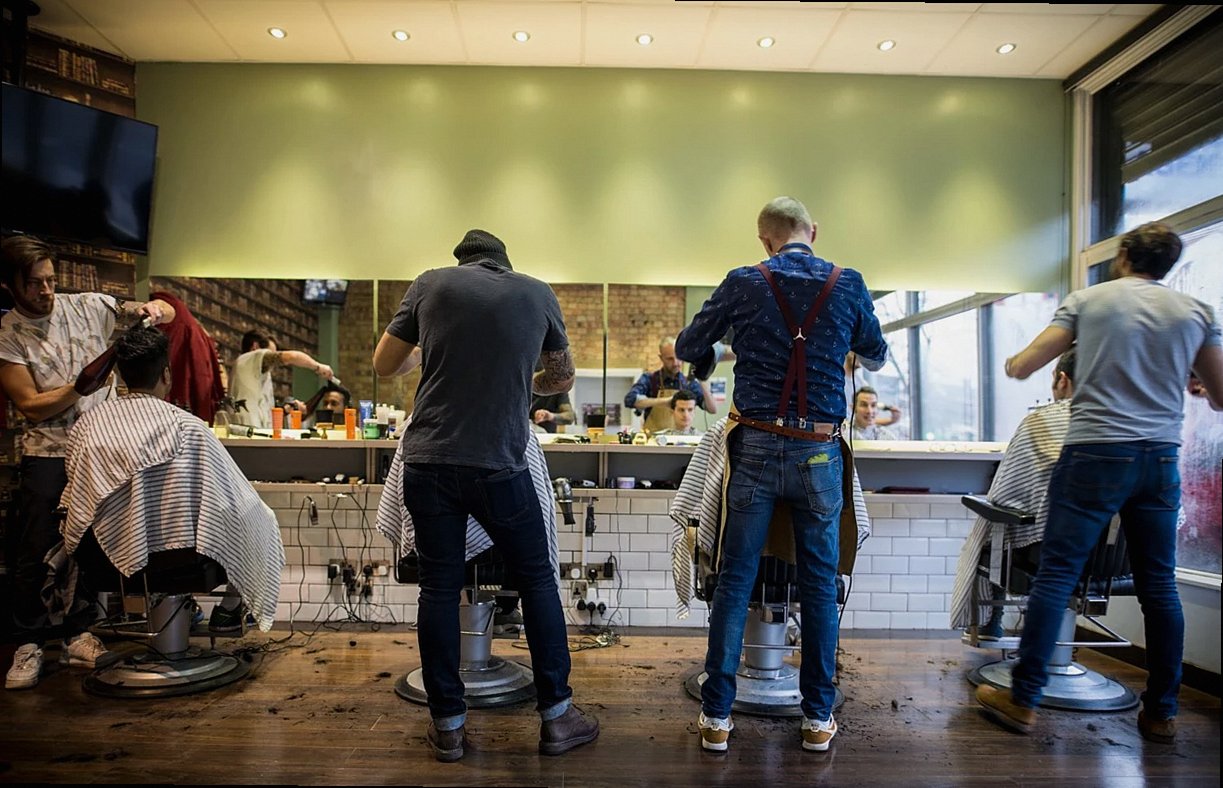 Barber chair and scissors at Charcoal Unit barbershop on Rua do Almada, Porto